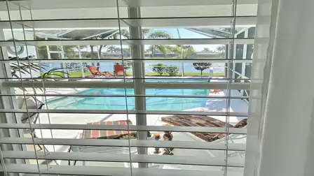 View from the master bedroom over the pool to the lake