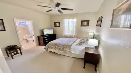 Bedroom with large double bed and view of the bathroom