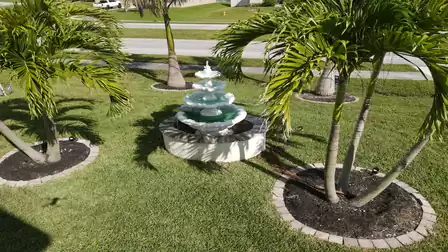 Fountain and nice palm trees in the front yard from Villa Golden Globe