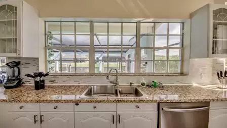 Large kitchen with view to the pool and terrace
