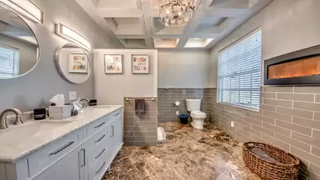 En suite bathroom with double sink and walk-in shower