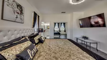 A large screen TV and a closet with mirrored sliding doors complete the suite.