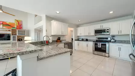 The open kitchen, decorated in white, invites you to cook