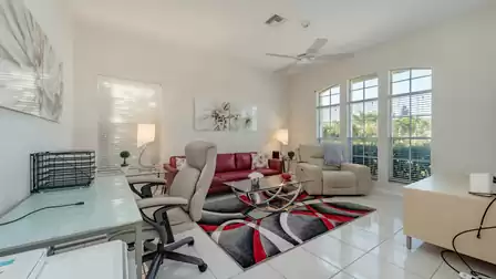 In another living area with leather sofa is a desk for writing cards for loved ones at home