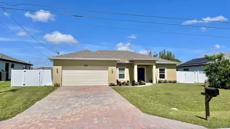 Inviting vacation home with a well-kept front yard and large driveway.
