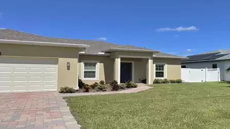 Front entrance with covered entryway and beautiful front yard.