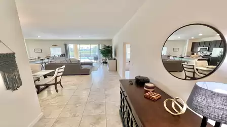 Hallway with view of the living room and pool area.
