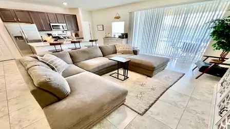 Open-concept kitchen with bar stools and modern appliances.