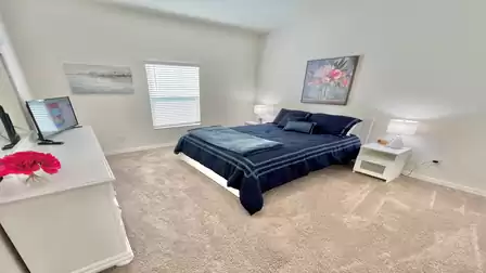 Stylish bedroom with an elegant king-size bed and harmonious color scheme.