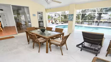 A dining table on the covered terrace offers space for 6 people