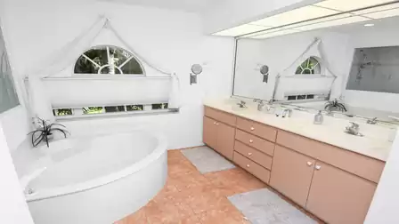 The main bathroom is decorated in pink and white