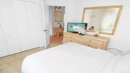 All in white—queen-size bed and TV in the 2nd bedroom