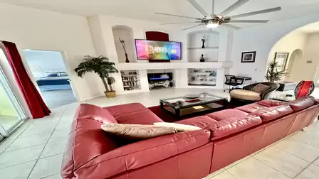 Sit back and relax on the red leather living room sofa