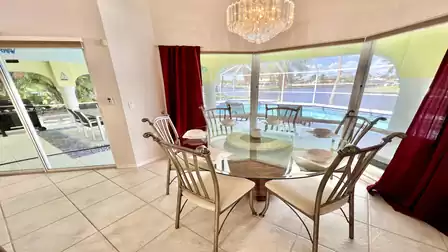 Dining area with glass table and 6 chairs - great view of the water included