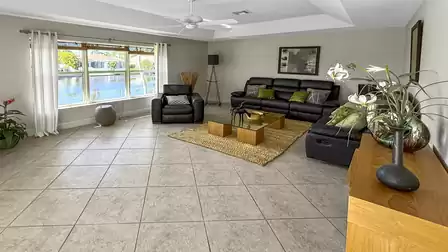 The huge living area fascinates with comfortable sofas and a TV set