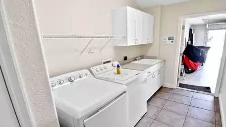 Laundry room with washer and dryer and access to the garage