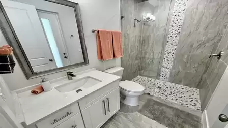 This bathroom is also kept in gray and white
