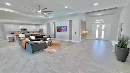 View of the living room and the kitchen behind it