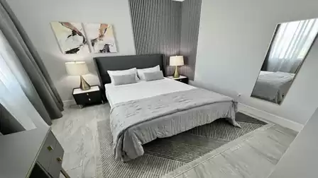 The second bedroom is furnished with a queen size bed