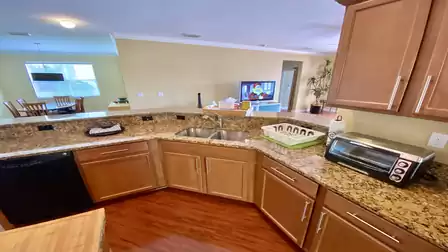 Who can watch TV at home while washing the dishes