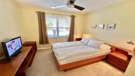 Bedroom with queen size bed and view to the street