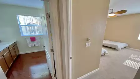View into the bathroom between the two bedrooms with the single beds