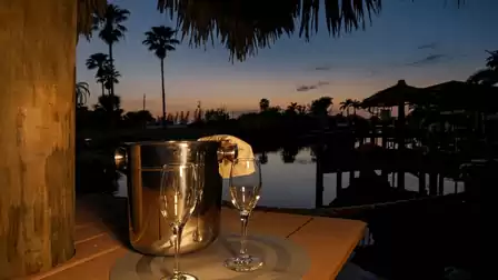A glass of champagne on the dock at the end of the day