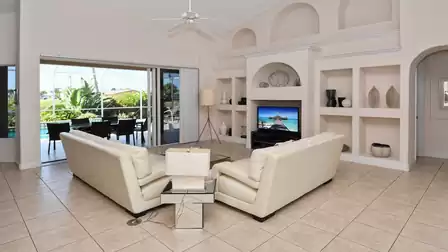 The spacious living room features a large flat screen TV