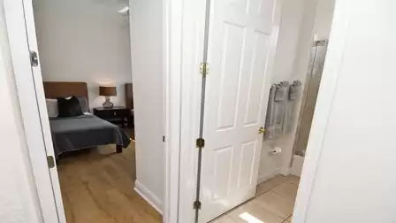 Hallway between the other two bedrooms and the bathroom