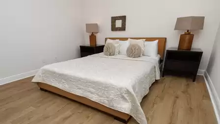 The stylish second bedroom features a Queen size bed