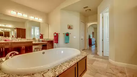 Elegant master bathroom with a freestanding bathtub, double sinks, and granite countertops.