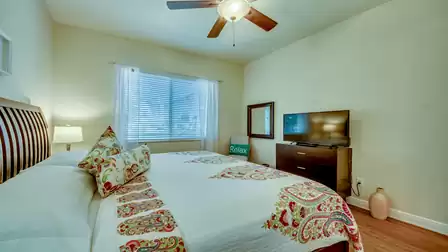 Bright bedroom with a large window, cozy bed, and relaxing atmosphere.