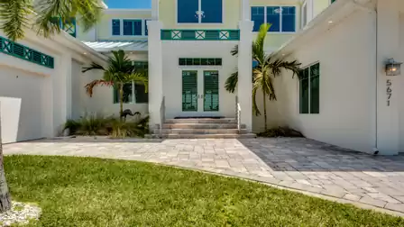 Stunning pool area of Villa River King overlooking the Caloosahatchee River with luxurious amenities.