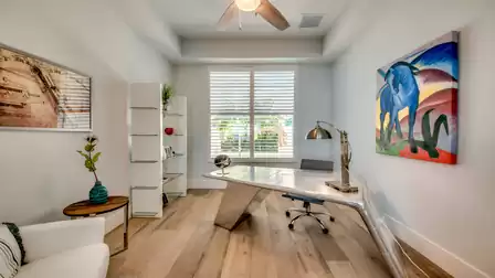 Bright office with designer desk and colorful wall painting