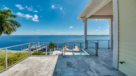 Stunning balcony view of the water and tropical landscape.