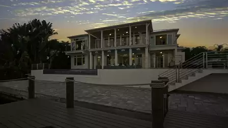 Backside of the vacation home with spacious pool area and canal view.