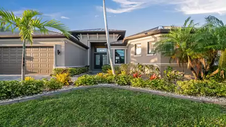 Entrance area of Villa Elvenar, surrounded by tropical landscaping and stylish design.