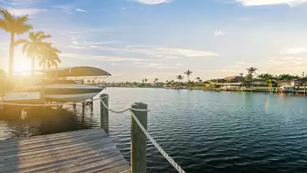 Motorboat on the boat lift of Villa Elvenar, stunning sunset view over the canal.