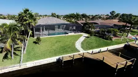 Another aerial view of the vacation home with a large property and direct access to the canal.