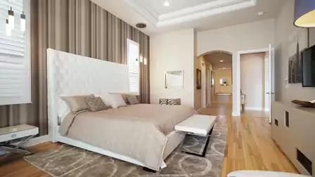 Cozy master bedroom with a large bed, modern accents, and a view of the adjoining bathroom.
