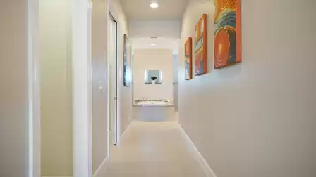 Bright hallway with stylish wall paintings and direct access to the spacious bathroom.