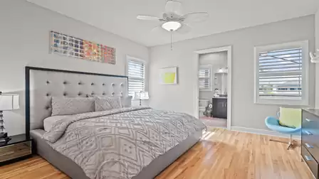 Elegant bedroom with a large bed, bright walls, and direct access to the en-suite bathroom.