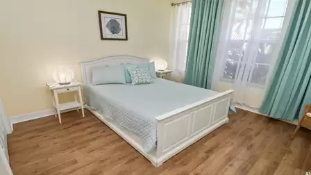 Bright and inviting third bedroom with queen size bed