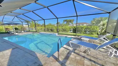 Pool with screened patio and cozy seating area.