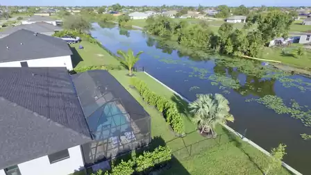 Aerial view of the house with pool and direct canal access.