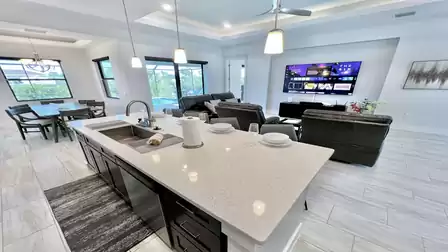 Open kitchen with dining area and pool view.