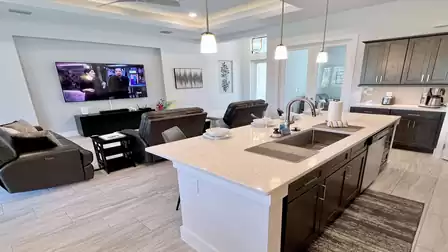 Stylish kitchen with dark cabinets and stainless steel appliances.