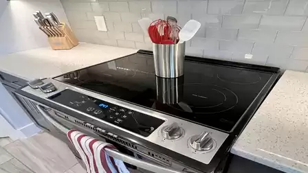 Glass-ceramic cooktop with high-quality kitchen utensils.