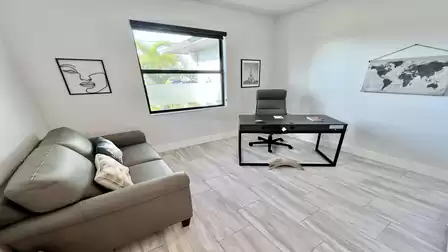 Office space with desk and guest sofa.