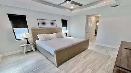 Modern master bedroom with large bed and stylish decor